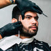 Hair Stylist Wearing Black Nitrile Gloves While Trimming Client Facial Hair 